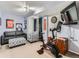 Finished basement featuring exercise equipment, comfortable seating, and a mounted TV at 11569 Grape St, Thornton, CO 80233