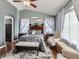 Comfortable main bedroom featuring vaulted ceiling, ceiling fan, and natural light at 11569 Grape St, Thornton, CO 80233