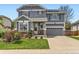 Charming two-story home with a well-manicured lawn, inviting entrance, and an attached two-car garage at 11569 Grape St, Thornton, CO 80233