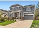 Charming two-story home with a well-manicured lawn, inviting entrance, and an attached two-car garage at 11569 Grape St, Thornton, CO 80233
