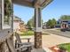 Inviting front porch with decorative plants, charming chairs, and decorative accents for a warm welcome at 11569 Grape St, Thornton, CO 80233