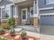 Inviting front porch with decorative plants, charming chairs, and decorative accents for a warm welcome at 11569 Grape St, Thornton, CO 80233