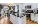 Eat-in kitchen features stainless steel appliances, subway tile backsplash and granite countertops at 11569 Grape St, Thornton, CO 80233