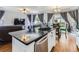 Open concept kitchen flows into living room with hardwood floors and plenty of natural light at 11569 Grape St, Thornton, CO 80233