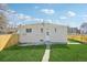 Spacious backyard featuring a well-maintained lawn and a white-painted brick house exterior at 2295 S Sherman St, Denver, CO 80210