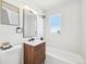 Modern bathroom featuring a stylish vanity, updated fixtures, and a combination shower and bathtub at 2295 S Sherman St, Denver, CO 80210