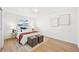 Comfortable bedroom with modern accents, a cozy bed, hardwood floors, and natural light from the window at 2295 S Sherman St, Denver, CO 80210