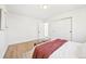 Bright bedroom features hardwood floors, white walls, a closet, and a window that provides natural light at 2295 S Sherman St, Denver, CO 80210