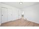 Spacious bedroom featuring hardwood floors, white walls, closet, with view to living room and natural light at 2295 S Sherman St, Denver, CO 80210