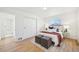 Inviting bedroom with white walls, hardwood floors, closet, and a bright window offering natural light at 2295 S Sherman St, Denver, CO 80210
