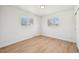Minimal bedroom featuring hardwood floors, white walls, and two windows, offering natural light at 2295 S Sherman St, Denver, CO 80210