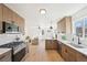 Modern kitchen with stainless steel appliances, sleek cabinetry, white countertops, and subway tile backsplash at 2295 S Sherman St, Denver, CO 80210