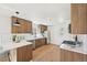 Well-lit kitchen with stainless steel appliances, white countertops, wood cabinets, and tile backsplash at 2295 S Sherman St, Denver, CO 80210