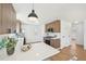 Bright kitchen with white marble countertops, island seating, and stainless steel appliances at 2295 S Sherman St, Denver, CO 80210