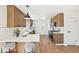 Stylish kitchen featuring a breakfast bar, stainless steel appliances, wood cabinets, and hardwood floors at 2295 S Sherman St, Denver, CO 80210