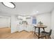 Modern kitchenette featuring white cabinets, countertops, and hardwood floors at 2295 S Sherman St, Denver, CO 80210