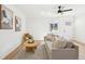 Cozy living room featuring contemporary decor, a ceiling fan, and natural light from the nearby windows at 2295 S Sherman St, Denver, CO 80210