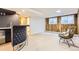 Finished basement showcasing a wet bar, seating area, and wood-paneled accent wall at 10295 E Evans Ave # 114, Aurora, CO 80247