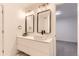 Bright bathroom featuring a double vanity with modern fixtures and mirrors at 10295 E Evans Ave # 114, Aurora, CO 80247