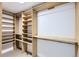 Walk-in closet with custom wood shelving and hanging rods for optimal storage at 10295 E Evans Ave # 114, Aurora, CO 80247
