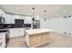 Bright kitchen with stainless steel appliances, an island with seating, and modern pendant lighting at 10295 E Evans Ave # 114, Aurora, CO 80247