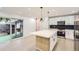 Modern kitchen featuring white cabinets, stainless steel appliances, and a large island at 10295 E Evans Ave # 114, Aurora, CO 80247