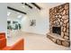 Spacious living room with a stone fireplace, skylights, vaulted ceilings, and natural light at 10295 E Evans Ave # 114, Aurora, CO 80247