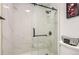 Luxurious walk-in shower showcasing marble tile, black fixtures, and frameless glass at 10295 E Evans Ave # 114, Aurora, CO 80247