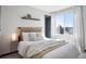 Cozy bedroom with soft, neutral tones and a large window, creating a serene atmosphere at 1277 Quitman St, Denver, CO 80204