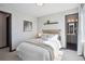 Cozy bedroom with neutral tones, stylish decor, and an en suite bathroom at 1277 Quitman St, Denver, CO 80204
