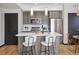 Modern kitchen featuring stainless steel appliances, white countertops, and island seating at 1277 Quitman St, Denver, CO 80204