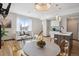 Open-concept living room with modern decor, island seating, and large window at 1277 Quitman St, Denver, CO 80204