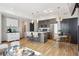 Bright living room featuring modern decor, island seating, and large window at 1277 Quitman St, Denver, CO 80204