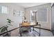 Bright and airy office space with a wooden desk, decorative rug, and modern art at 1277 Quitman St, Denver, CO 80204