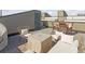Cozy roof deck features a grill and comfortable seating for relaxing and enjoying the outdoors at 1277 Quitman St, Denver, CO 80204