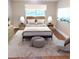 Staged bedroom featuring a plush bed, contemporary lamps, soft rug, and tasteful decor for a serene ambiance at 9300 E Center Ave # 6A, Denver, CO 80247