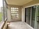 Sunroom with glass window features, neutral-toned walls, and tile floors leading to a sliding glass door at 9300 E Center Ave # 6A, Denver, CO 80247