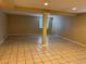 Open basement area with tile flooring and column, offering potential for customization at 20304 E 47Th Pl, Denver, CO 80249