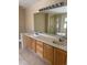 Bathroom featuring a double sink vanity, large mirror, and a glass shower at 20304 E 47Th Pl, Denver, CO 80249