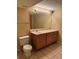 Functional bathroom featuring vanity, toilet, and ample lighting, ready for updates at 20304 E 47Th Pl, Denver, CO 80249
