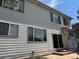 Rear exterior showing white siding, windows, and a sliding glass door with access to the backyard at 20304 E 47Th Pl, Denver, CO 80249