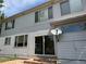 Back exterior featuring siding, windows, and sliding glass door leading to a patio area at 20304 E 47Th Pl, Denver, CO 80249