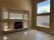 Bright living room with a fireplace, tile flooring and large windows offering ample natural light at 20304 E 47Th Pl, Denver, CO 80249