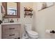 Powder room with wood vanity and rustic decor at 3238 Brushwood Dr, Castle Rock, CO 80109