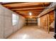 Unfinished basement space featuring open ceiling, wood flooring, and a window for natural light at 495 Bexley St, Highlands Ranch, CO 80126