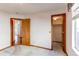 Bedroom featuring neutral walls, trim and carpet with doorway to closet and access to hallway at 495 Bexley St, Highlands Ranch, CO 80126
