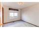 Bright bedroom with a window, neutral carpet, and trim throughout the space at 495 Bexley St, Highlands Ranch, CO 80126