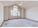 Bedroom with vaulted ceiling, large window and neutral carpeting and trim at 495 Bexley St, Highlands Ranch, CO 80126