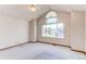 Sun-filled bedroom featuring a large arched window offering neighborhood views at 495 Bexley St, Highlands Ranch, CO 80126