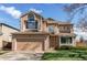 Inviting two-story home with a two-car garage and well-manicured lawn at 495 Bexley St, Highlands Ranch, CO 80126